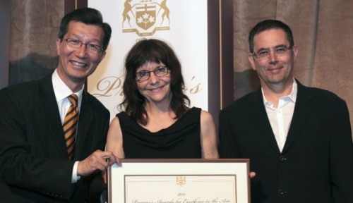 Ontario Minister of Tourism and Culture Michael Chan (left) presents the Premier's Award for Excellence in the Arts to Vtape co-founders Lisa Steele and Kim Tomczak
